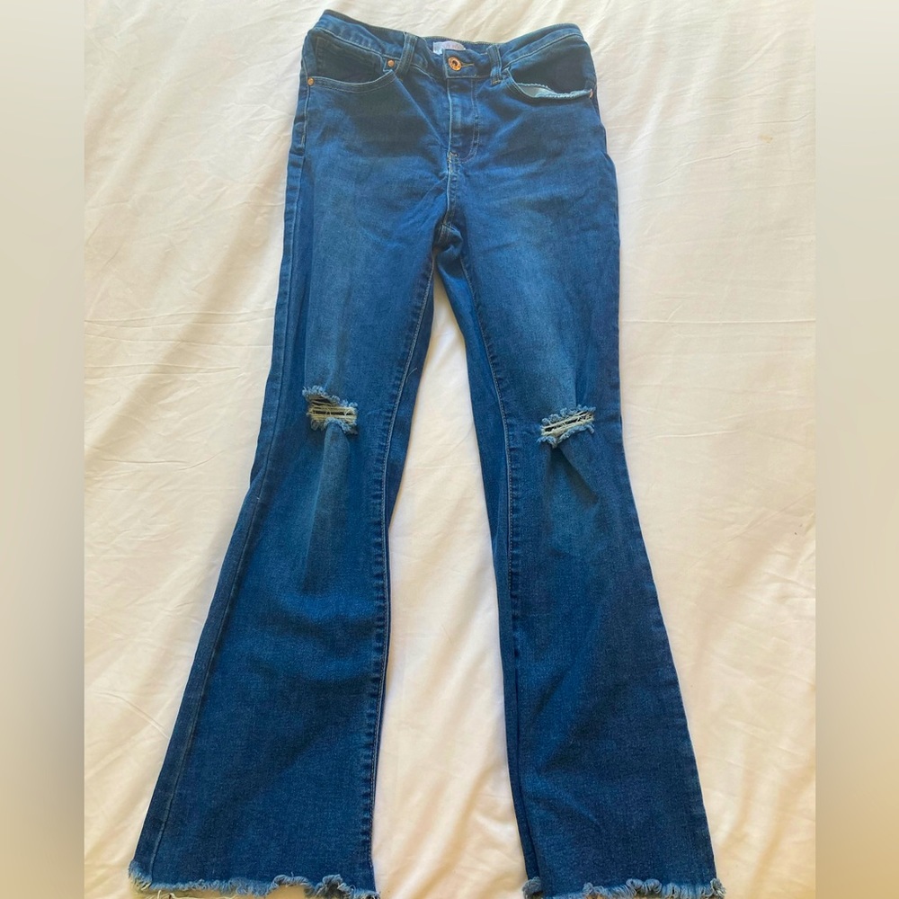 Ripped flared blue jeans